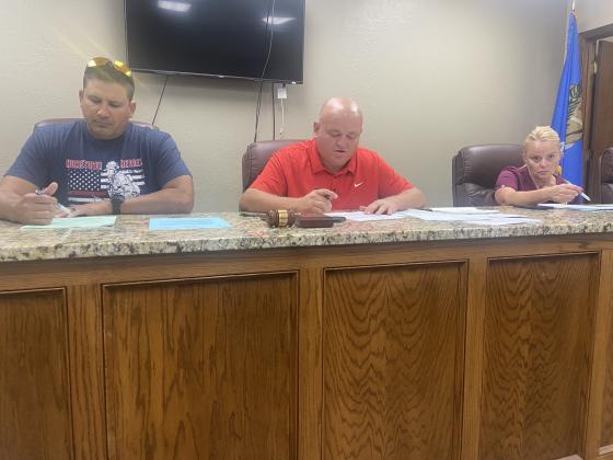 From the left, Elgin City Councilman Fred Guevara, Mayor JJ Francais and Councilwoman Nettie Evans review documents before Monday’s special meeting. The council designated the time slot from 6-8 p.m. Oct. 31 as Elgin’s official trick-or-treat night. Eric Swanson/Staff photo