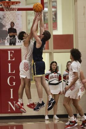 Owl defender Christian Reed, left, tries to a block a shot from a Kingfisher player during last Friday’s game. HUGH SCOTT JR. | SOUTHWEST CHRONICLE