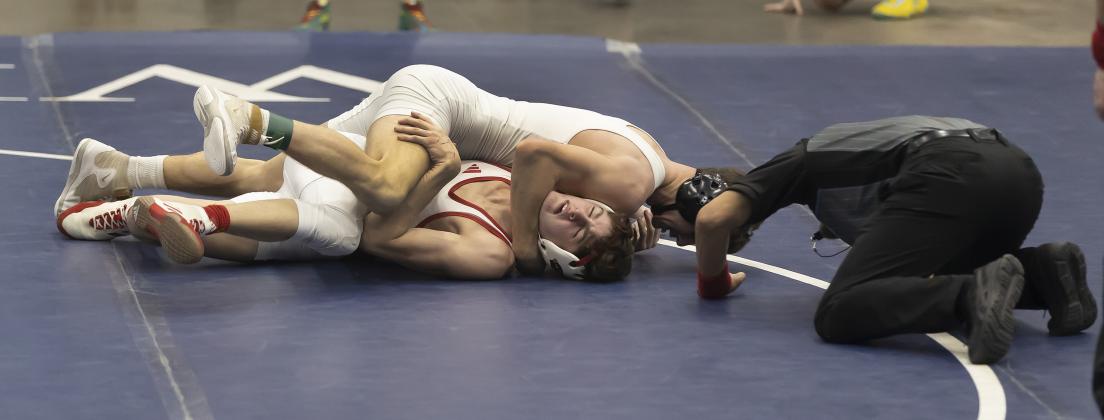 Elgin’s Austin Elam works to pin his Collinsville opponent during Saturday’s semifinal match at 138 pounds. Elam won by injury default during the second period. HUGH SCOTT JR. | SOUTHWEST CHRONICLE