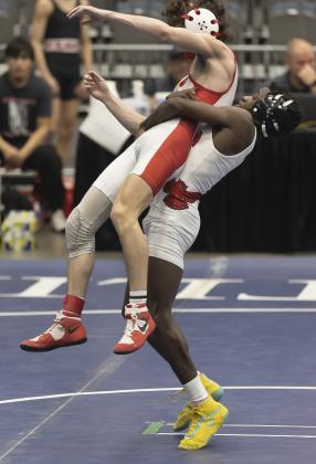 Owl grappler Brice Martin, right, lifts his opponent during semifinal action Saturday. Martin won his match by fall. HUGH SCOTT JR. | SOUTHWEST CHRONICLE