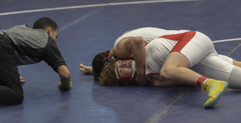 Owl grappler Jonavin Mullins, (top) is about to pin his opponent during Elgin’s semifinal dual. Mullins pinned his opponent in the 175-pound match at 1:43 of the second period. HUGH SCOTT JR. | SOUTHWEST CHRONICLE