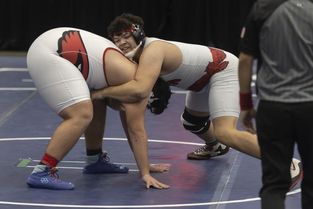 Elgin heavyweight Shea Spencer, right, gains control of his opponent and later earns a 5-2 win to boost the Owls into an early team lead. HUGH SCOTT JR. | SOUTHWEST CHRONICLE