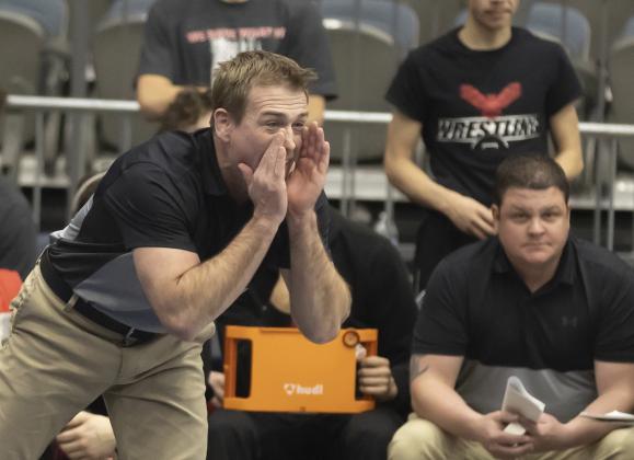 Elgin head coach Cody Rowell yells instructions to an Owl wrestler during the Dual State competition. Elgin won the Dual State title with a convincing win over No. 2 ranked Coweta. HUGH SCOTT JR. | SOUTHWEST CHRONICLE