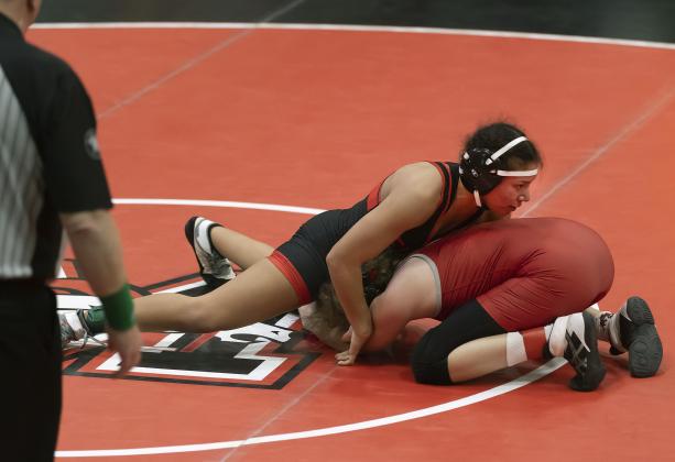 Junior Symphony Veloz works to pin her opponent in the first-place match of the 170-pound weight class at the 6A West Regional tournament. Veloz won by fall and took home the regional championship. She will compete in this week’s state tournament. HUGH SCOTT JR. | SOUTHWEST CHRONICLE