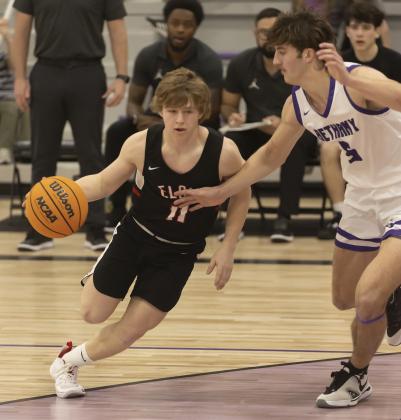 Elgin junior Denton Glover (11) dribbles into the lane during regional tournament action last week. The Owls won the regional tournament to advance to the Area Tournament this week in Hennessey. HUGH SCOTT JR. | SOUTHWEST CHRONICLE