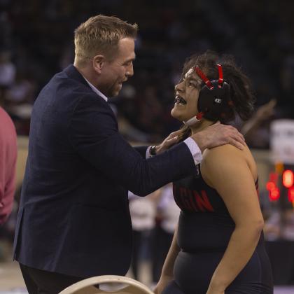 Two-time state champion Symphony Veloz is congratulated by her coach, Cody Rowell, after she won the Class 6A state title at 170 pounds. HUGH SCOTT JR. | SOUTHWEST CHRONICLE