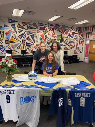 Sarah Schuh, seated, signs a ceremonial letter of intent to play volleyball at Rose State College in the fall. Schuh is expected to be a defensive specialist at Rose State. PHOTO PROVIDED