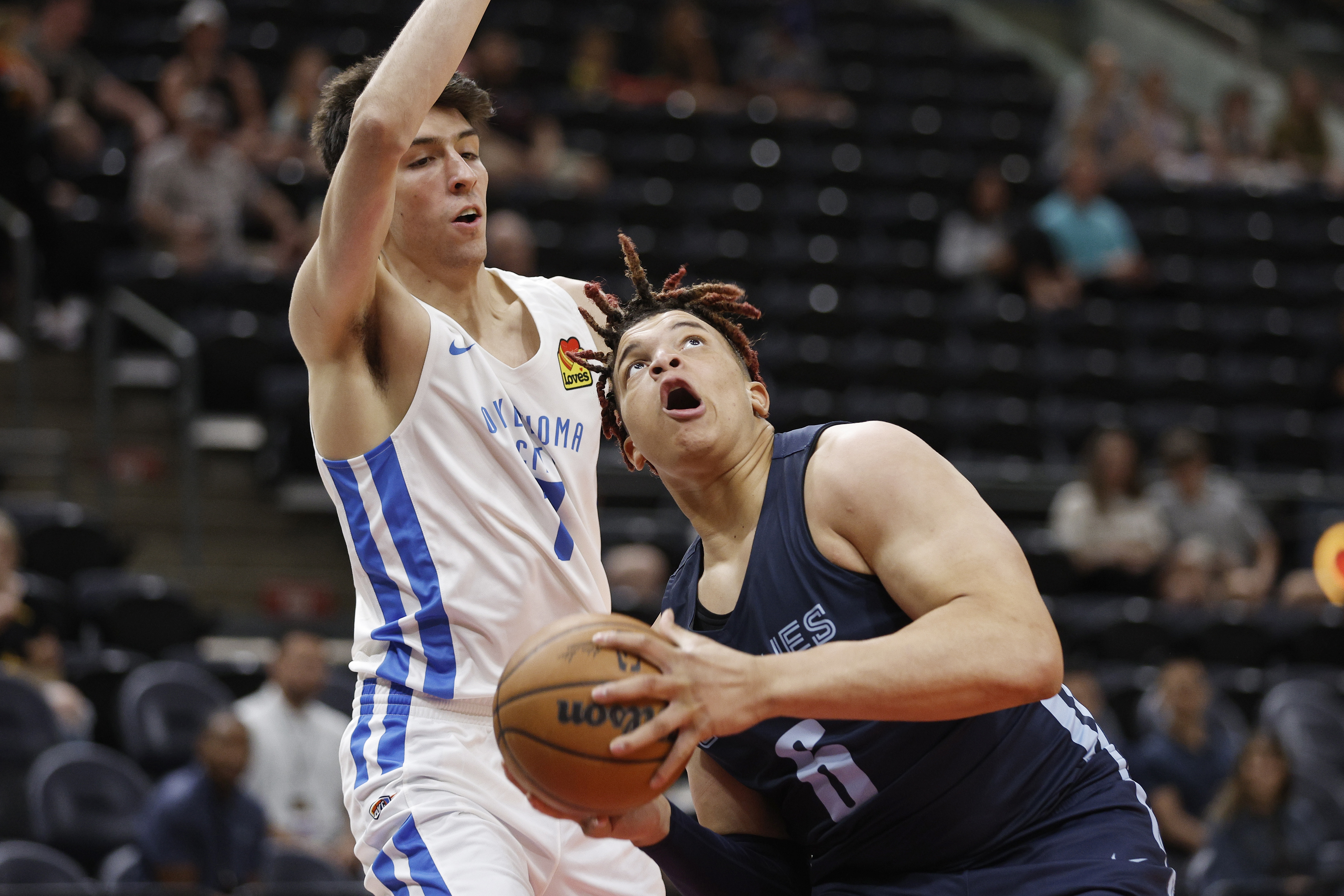 Memphis Grizzlies forward Kenny Lofton Jr. (6) looks to shoot against Oklahoma City Thunder forward Chet Holmgren (7) during the first half of an NBA summer league basketball game Wednesday, July 6, 2022, in Salt Lake City.  (AP Photo/Jeff Swinger)