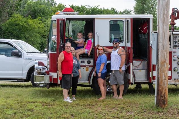 : Left to right, Byron and Cindy Pennington, Caylee, Braylee, Amber and Ryan Anderson gather in front of one of Paradise Valley Volunteer Fire Department’s fire engines during the Paradise Valley Volunteer Fire Department’s annual fish fry.