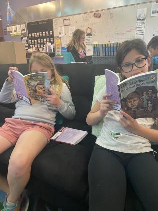 Hailey Hartford gets a better understanding of the hardships America faced during the Great Depression as Lydia Ceballos reads over the Dec. 7, 1941, attack on Pearl Harbor, Hawaii.