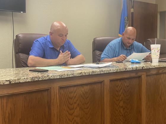 : From the left, Elgin Mayor JJ Francais and Councilman Josh Thoma prepare for Monday’s special meeting. The council unanimously approved new maps of the city’s voting wards.  Eric Swanson/Staff photo