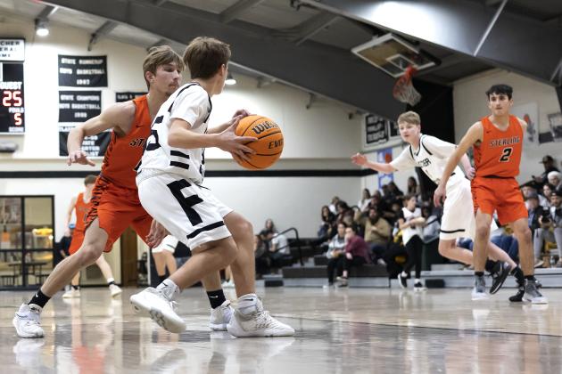 Sterling’s Nate Anderson (0) and teammate Max Puccio (2) press Fletcher in the backcourt during Tuesday’s game. The defensive pressure created several turnovers for Sterling. HUGH SCOTT JR. | SOUTHWEST CHRONICLE