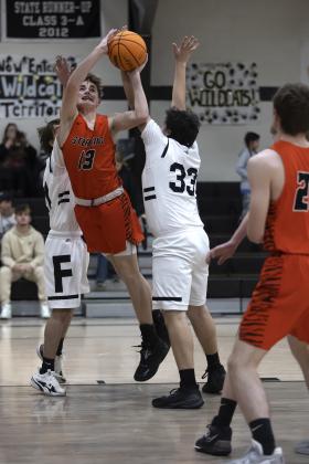Riley Lile (13) shoots an off-balanced shot against Fletcher Tuesday night. Lile finished with six points in the Sterling win. HUGH SCOTT JR. | SOUTHWEST CHRONICLE