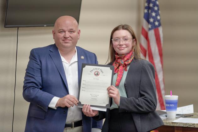 From the left, Elgin Mayor JJ Francais congratulates Elgin Middle School eighth-grader Josie Chandler, who was presented with a mayoral citation during an Elgin City Council meeting Feb. 16 for her third-place win in OML’s “If I Were Mayor” essay contest. CHRISTOPHER BRYAN