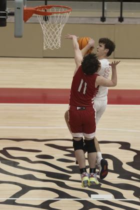Elgin senior Christian Reed shoots the ball over the outstretched hands of a Plainview defender during the Purcell Tournament. Elgin lost to Tuttle last Friday but will try to get back on the winning track Feb. 3 at Bethany. HUGH SCOTT JR. | SOUTHWEST CHRONICLE