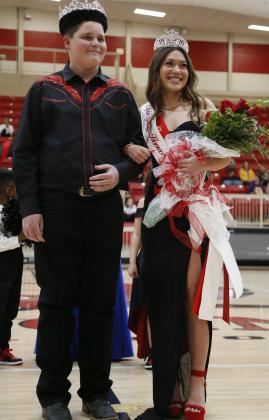 Spring homecoming Queen Mikayla Arnold, right, smiles to the crowd after being crowned Tuesday night. At her left is homecoming King Hunter McDonald. The ceremony occurred before the start of the girls varsity basketball game. Arnold represented Elgin’s slow-pitch softball team. RIP STELL | SOUTHWEST CHRONICLE