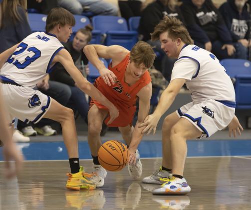 Sterling senior Nate Anderson dribbles between a pair of Union City defenders during regional tourney action. Anderson finished his last high school basketball game with 19 points. HUGH SCOTT JR. | SOUTHWEST CHRONICLE