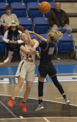 Lady Tiger Ashlyn Clift (14) is smacked in the face after passing the ball to a teammate during regional tournament action against Cordell. HUGH SCOTT JR. | SOUTHWEST CHRONICLE