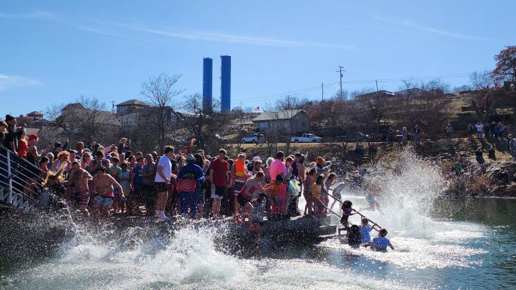 About 200 people braved the not-quite-freezing water of Bath Lake last Saturday to take part in Medicine Park’s annual Polar Plunge. STEVE BOOKER | SOUTHWEST CHRONICLE