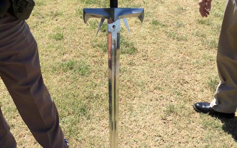 Brandishing this sword, Robert Sturgis Powers is accused of threatening a Hilliary Communications employee and stabbing the front tires of a company bucket truck.