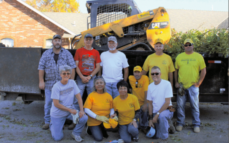 A group of ten Southern Baptist Disaster Relief volunteers take a quick break to pose for a group photo after cleaning up four yards