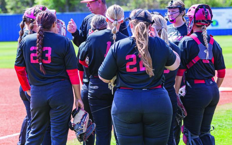 HUDDLE: Elgin's Lady Owls receive final instructions before starting their Regional softball tournament in Choctaw.  SW Chronicle photo by Rick Endicott