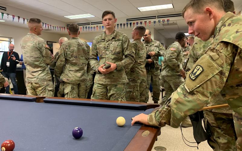 Soldiers enjoy the pool table and other recreation inside the newly opened B.O.S.S. House at Fort Sill. Sgt. Tyler Yount, B.O.S.S. president, said the house is designed to offer single Soldiers a place to decompress and socialize. He said they also focus on volunteer opportunities to connect with the Lawton-Fort Sill community and will soon offer weekly professional development classes.   FORT SILL PHOTO