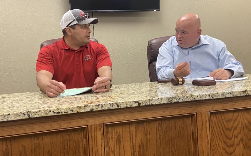: From the left, Elgin City Councilman Fred Guevara and Mayor JJ Francais discuss an issue during a council meeting April 21 at Elgin City Hall. The council voted to earmark the city’s entire ARPA allocation for government services.  Eric Swanson/Staff photo