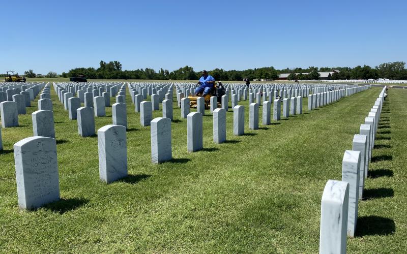 Pablo Lopez Jr., foreman for Byrd Enterprises, mows the grounds of Fort Sill National Cemetery in preperation for Memorial Day. SW Chonicle Photo by Curtis Awbrey