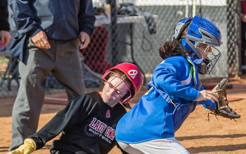 SLIDING HOME: Elgin's base runner slides in at home during the Fletcher tournament on April 15.  Photos by Rick Endicott