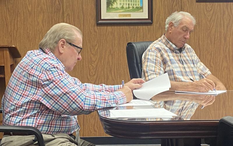 From the left, Comanche County Commissioners Johnny Owens and Gail Turner sign documents Monday at the Comanche County Courthouse. The commission voted 3-0 to earmark $1.3 million in American Rescue Plan Act dollars for each of the county’s three districts.  Eric Swanson/Staff photo