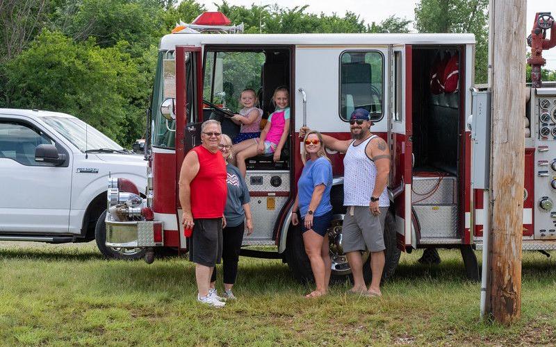 : Left to right, Byron and Cindy Pennington, Caylee, Braylee, Amber and Ryan Anderson gather in front of one of Paradise Valley Volunteer Fire Department’s fire engines during the Paradise Valley Volunteer Fire Department’s annual fish fry.