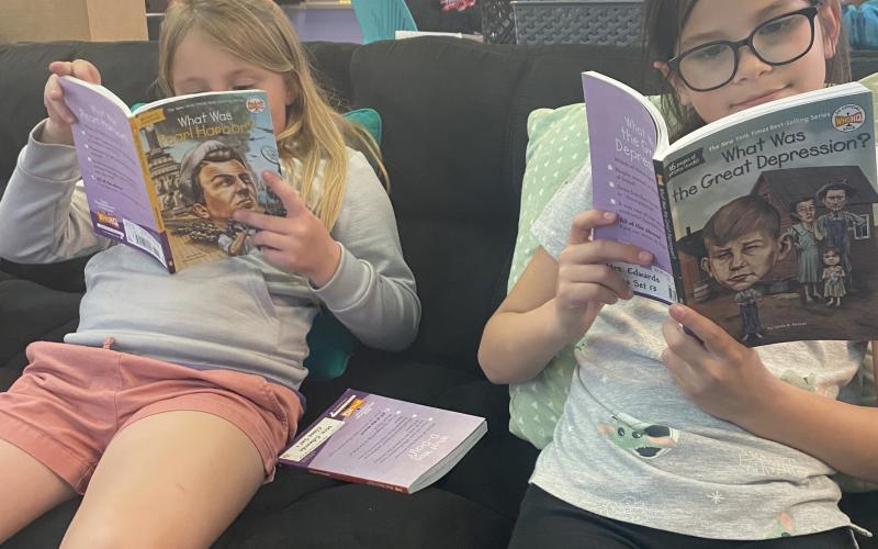 Hailey Hartford gets a better understanding of the hardships America faced during the Great Depression as Lydia Ceballos reads over the Dec. 7, 1941, attack on Pearl Harbor, Hawaii.