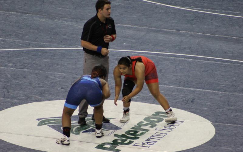 Elgin Lady Owl wrestler Symphony Veloz (red singlet) competes at the 16U National Championship in Fargo, North Dakota, defeating two other wrestlers to become an All-American. Photos by Melody Veloz