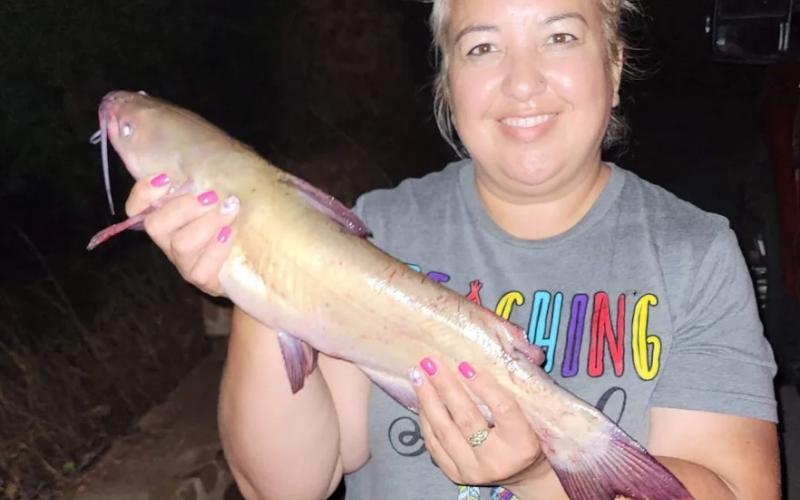 Marie R. with a channel catfish she caught at Lake Lawtonka July 19.  Photo courtesy Oklahoma Department of Wildlife Conservation
