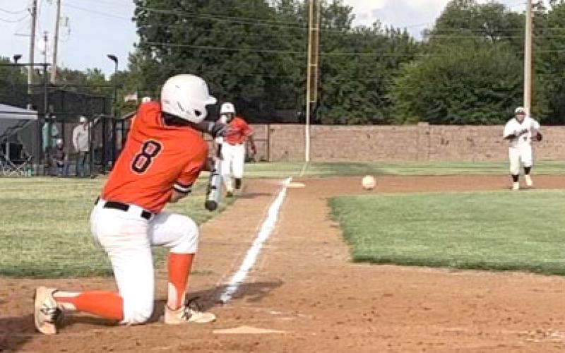 Tiger hitter Jayden Huitt hits the ball down the third baseline during the first game of the season against Granite.  Photos by Tania Huitt