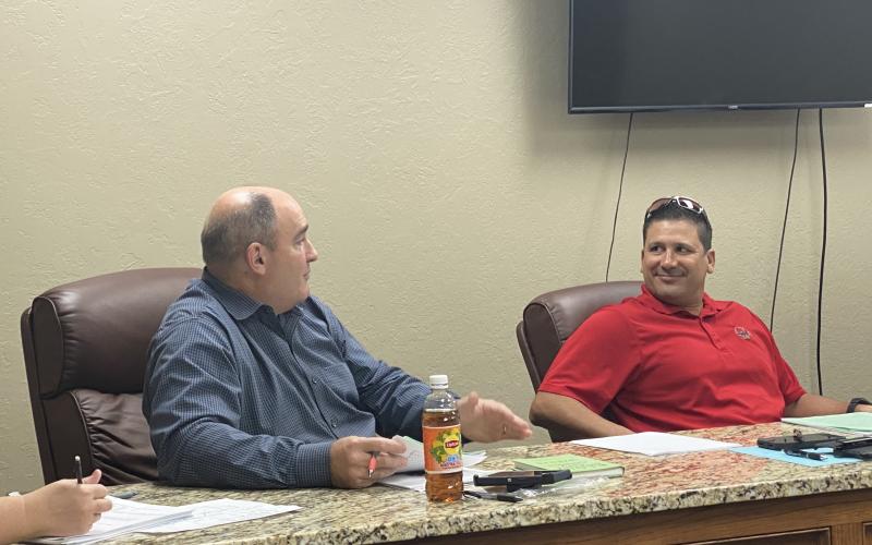 From the left, Elgin City Councilman Sean Bateman speaks while Councilman Fred Guevara listens during a meeting Tuesday at Elgin City Hall. The council created the new position of streets and parks superintendent, which will oversee the city’s street projects among other tasks. Curtis Awbrey/Staff photo