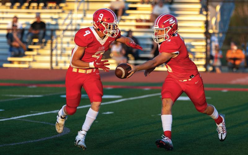 Elgin quarterback Tres Lorah (3) hands the ball to junior tailback Matthew Lund during first half action against Weatherford last Friday. Photo by Hugh Scott Jr.