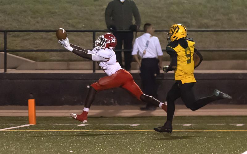 Junior wide receiver Michael Adesola (4) stretches for the winning TD catch in Elgin's come-from-behind 20-13 win over Lawton MacArthur Thursday night at Cameron Stadium. (Photo by Hugh Scott Jr.)