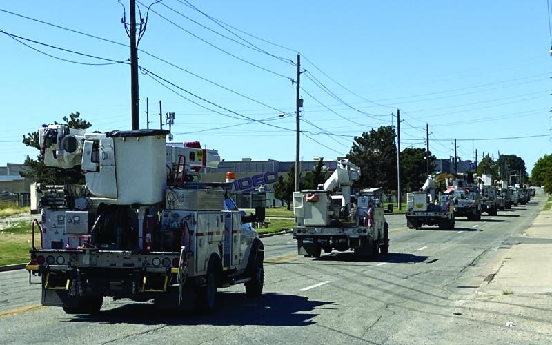 A caravan of Public Service Co. of Oklahoma utility trucks pulls out of a Tulsa facility Sept. 26 en route to Florida; crews also departed from Lawton and McAlester. The utility company sent 150 employees and business associates to Florida to help restore electric power disrupted by Hurricane Ian.  LEDGER PHOTO COURTESY WAYNE GREENE