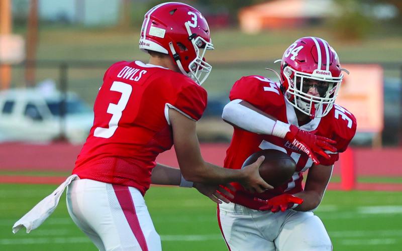 Elgin quarterback Tres Lorah (3) hands the ball off to running back Ritson Meyer during Friday's 35-0 win over Ardmore. (Photo by Hugh Scott Jr.)
