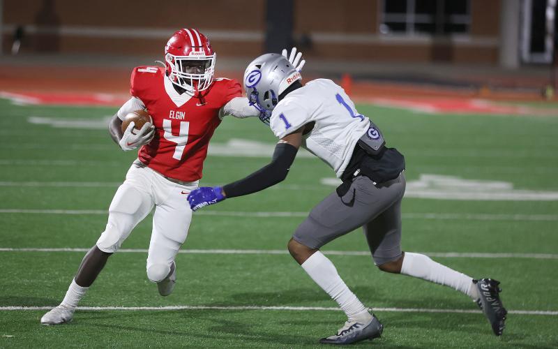 Elgin wide receiver Michael Adesola (4) tries to avoid a tackle by a Guthrie defender during Friday's playoff game. Adesola caught three passes for 26 yards in Elgin's 17-0 loss. (Photo by Hugh Scott Jr.)