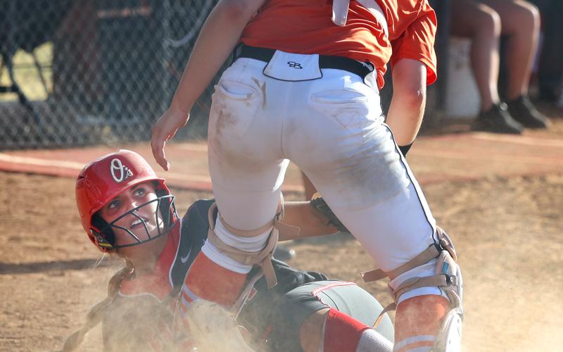 An Elgin baserunner slides into home while avoiding the tag by a Sterling catcher during fast pitch action this fall. HUGH SCOTT JR. | SOUTHWEST CHRONICLE