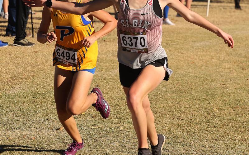 Elgin runner Audrey McElhaney crosses the finish line a second before Piedmont’s Lily Scheck at the Class 5A West regional. McElhaney finished second at the 5A state meet. HUGH SCOTT JR. | SOUTHWEST CHRONICLE