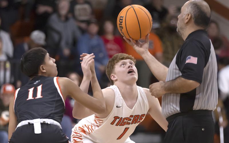 Hugh Scott Jr. | Southwest Chronicle Sterling’s Hayden Taliaferro (1) keeps a close eye on the ball as he prepares to tip off the first quarter of the Dec. 16 game with Apache. Apache defeated the Tigers 66-46 as Sterling dropped to 6-6 for the season.