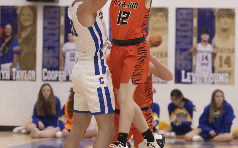 Sterling defender Tate Hughes goes high to swat the ball away from a Central High player during Tuesday's game. PHOTO BY HUGH SCOTT JR.