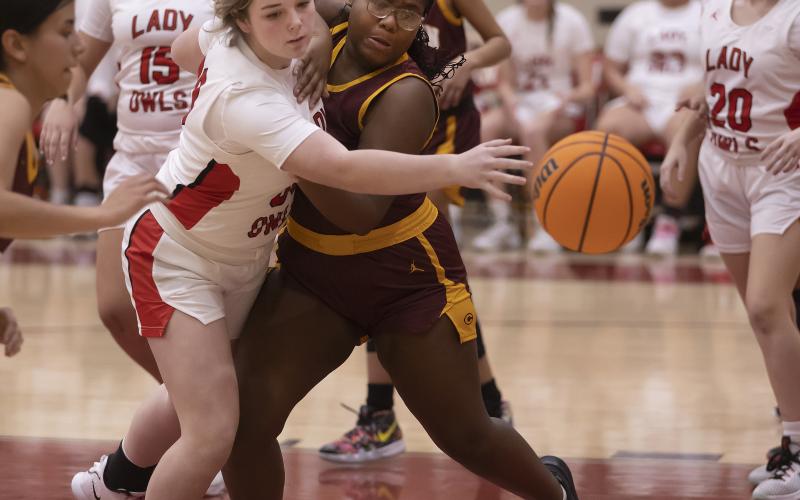 Braisley Wilson (30) and a Clinton defender lung for the ball during action Tuesday night. Elgin defeated the Red Tornadoes 60-30. HUGH SCOTT JR. | SOUTHWEST CHRONICLE