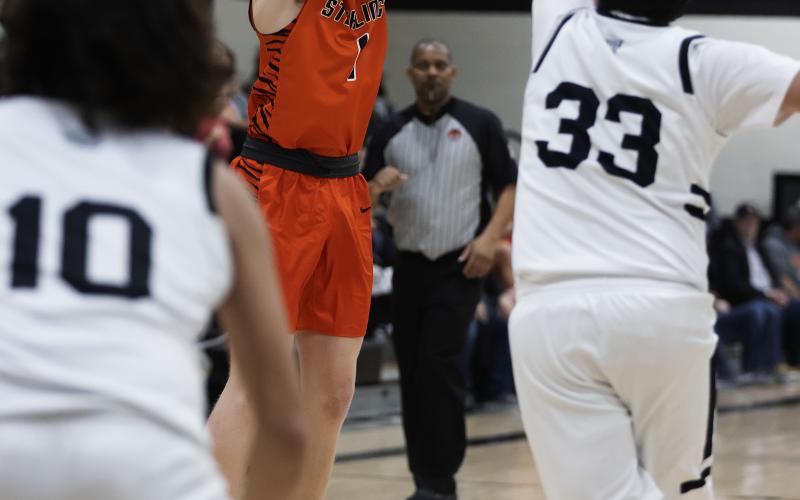 Sterling senior Hayden Taliaferro shoots over the hands of a Fletcher defender in a recent game. Taliaferro and teammate Max Puccio were named to the All-Tournament team at last week’s Black Diamond Tournament in Rush Springs. Sterling finished second. HUGH SCOTT JR. | SOUTHWEST CHRONICLE
