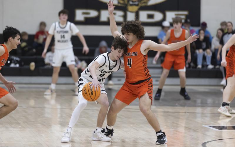 Sterling’s Jaydwen Huitt (4) guards a Fletcher player during Tuesday night’s action. Huitt finished with five points in the rivalry game. HUGH SCOTT JR. | SOUTHWEST CHRONICLE