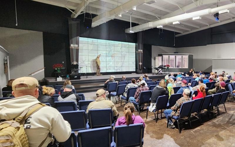 An Oklahoma Highway Patrol Community Response Team member briefs volunteers and law enforcement officials during an extensive, coordinated grid search of Cyril Wednesday at Family Life Church in Cyril. STEVE BOOKER | SOUTHWEST CHRONICLE